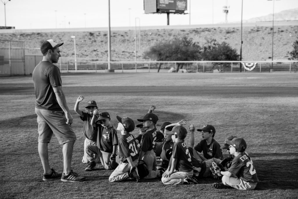 team huddled in front of coach